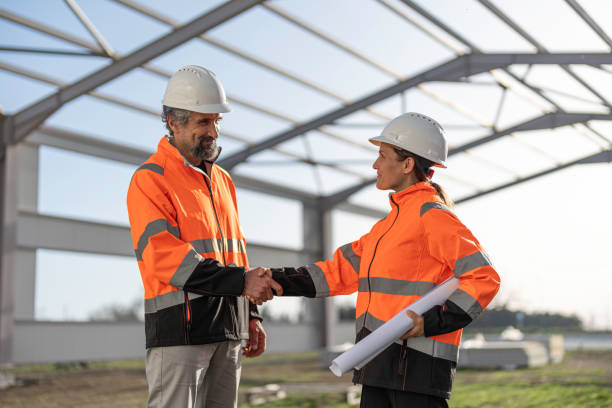 Professionals shaking hands to finalize a project for a hybrid steel building