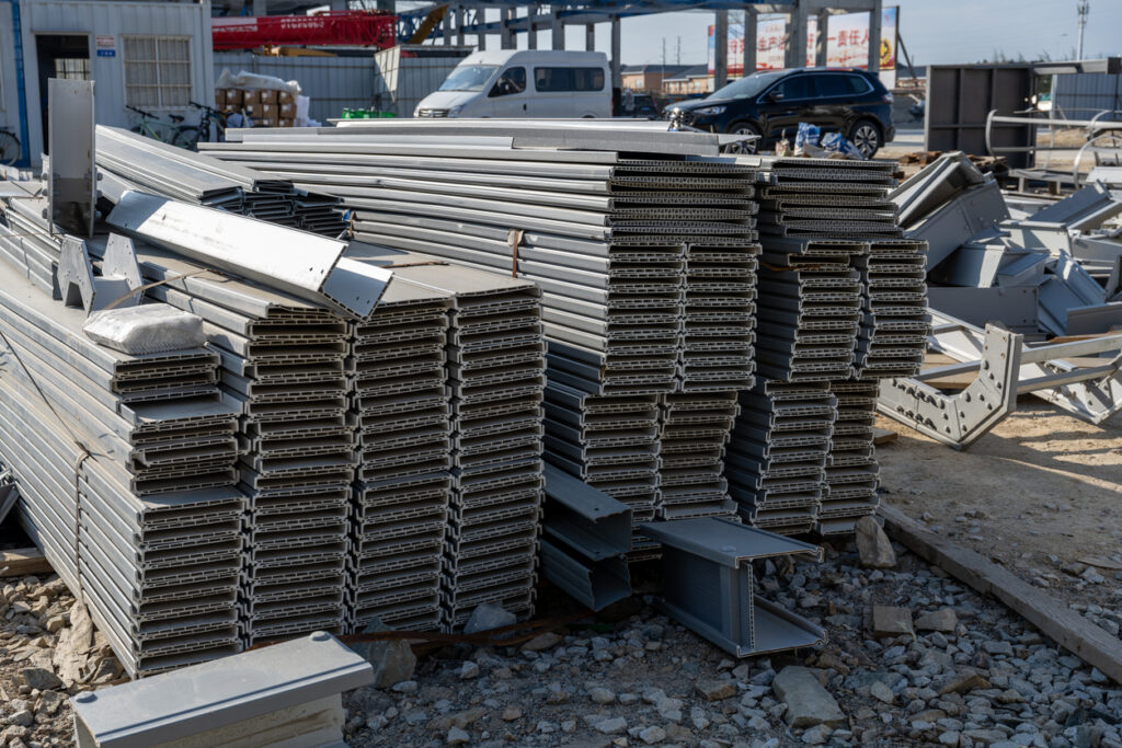 Stacked steel beams at a construction site for building steel structures