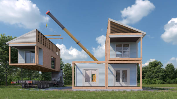 Crane lifting modular home section during construction process