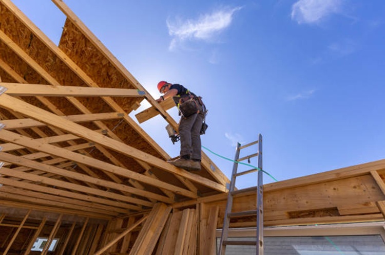 Worker constructing the roof during home building process