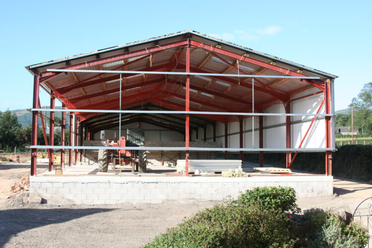 Farm shop under construction with steel frame and concrete foundation