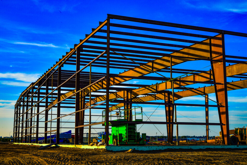 Steel frame structure of a building under construction in a clear sky
