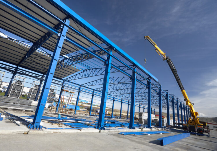 Steel structure of a building under construction with crane assistance