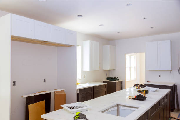 Kitchen addition construction in progress with cabinets and countertops installed