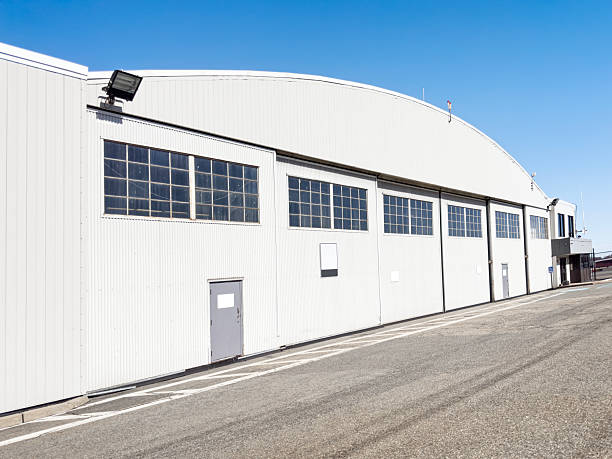 Aircraft hangar with closed sectional doors under clear blue sky