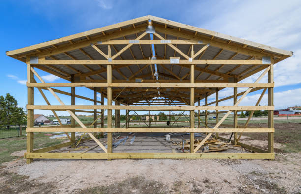 Framing structure of a post-frame pole barn under clear skies
