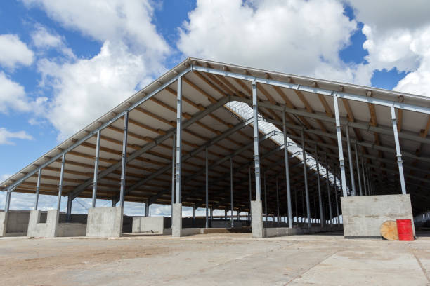 Shed under construction with a visible steel frame and roof installation