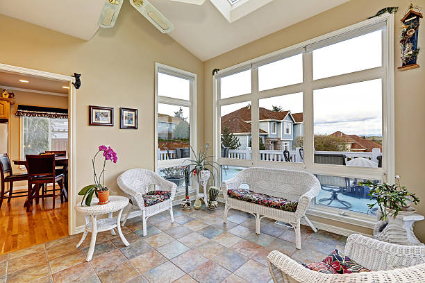 Constructed sunroom addition with natural light and cozy seating area