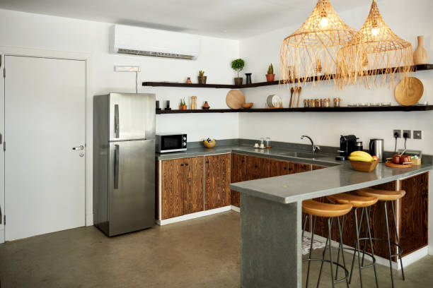 Modern kitchen with installed concrete countertops and wooden cabinets