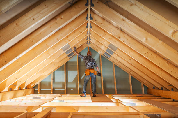 Contractor adjusting wooden beams during attic conversion