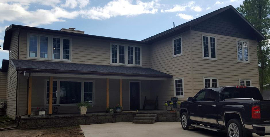 Newly renovated home exterior with modern windows and roofing