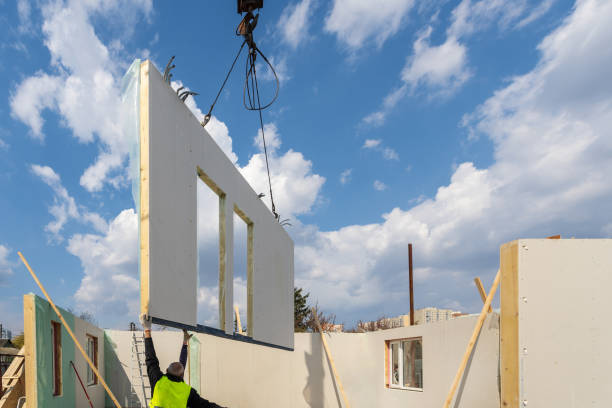 Crane placing wall panel during Modular Home Builder construction