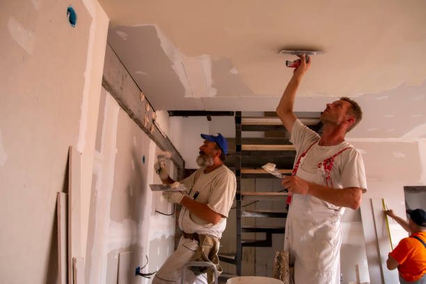 Workers finishing drywall as part of a home remodeling project
