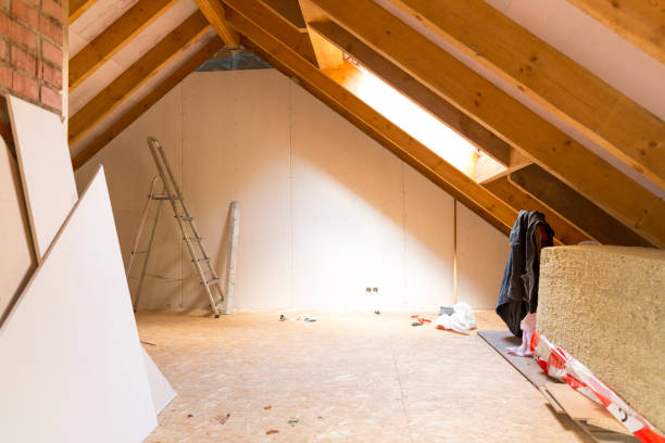 Attic conversion in progress with drywall installation and tools