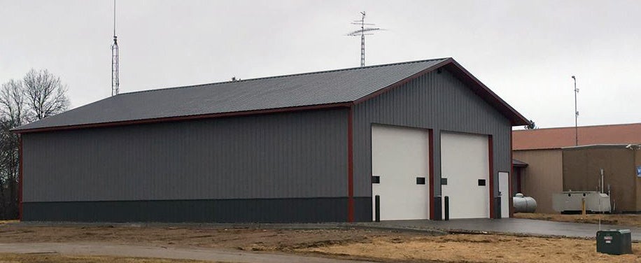 Newly finished farm shop construction with red trim and a steel roof