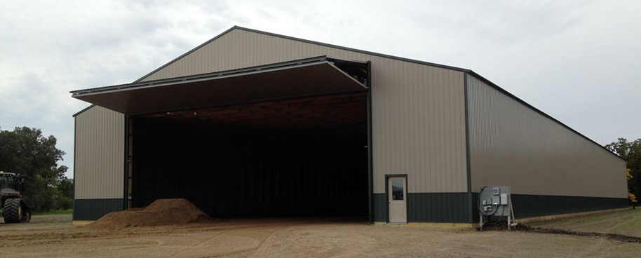 Newly installed bi fold hangar door operating on large industrial shed