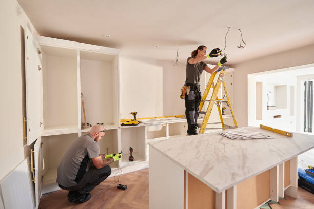 Professional home renovation contractors fitting new kitchen cabinets