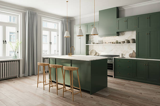 Stylish remodeled kitchen with green cabinetry and marble island