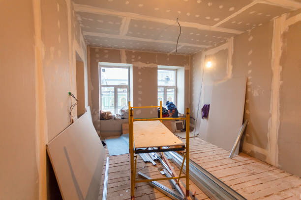 Interior home renovation in progress with drywall and scaffolding