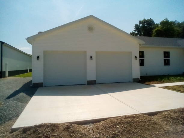 Newly built garage addition with double doors and driveway