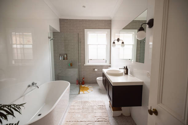 Newly built bathroom with tiled tub, sink, and modern fixtures